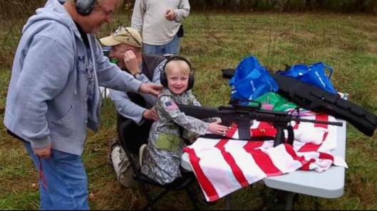 Four-year-old American child learns to us a machine gun